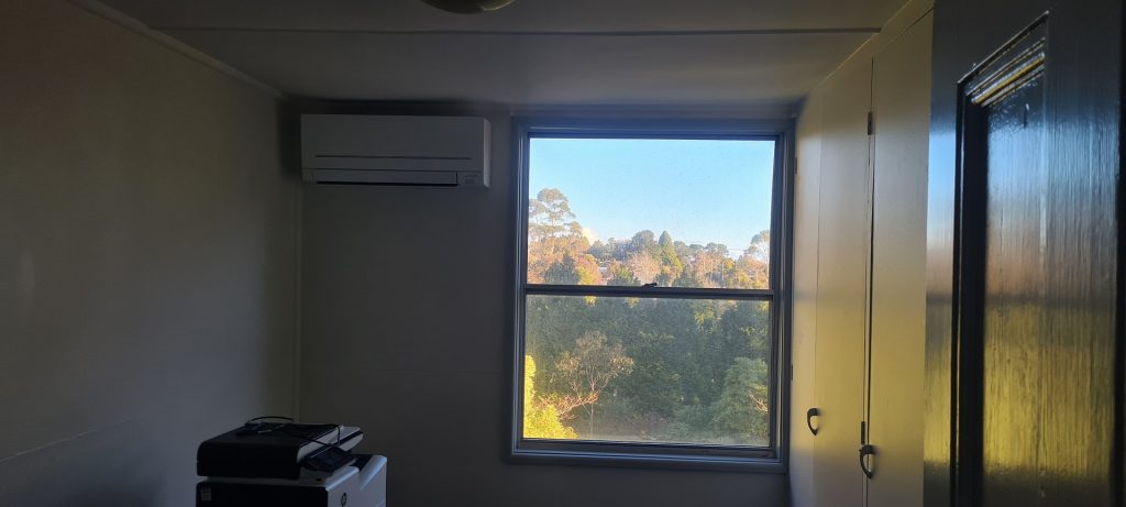 A dark living room with AC