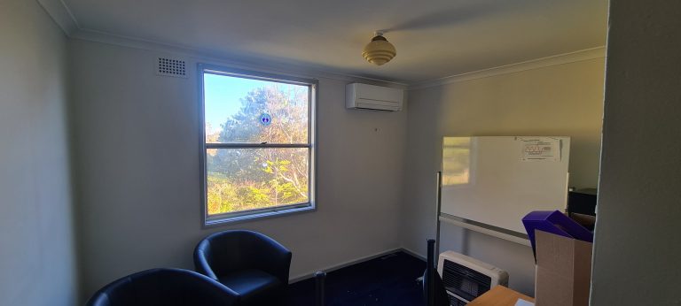A room with large window and an air conditioning installed