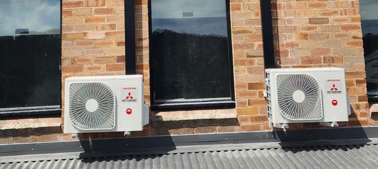 Two outdoor units of AC on a building