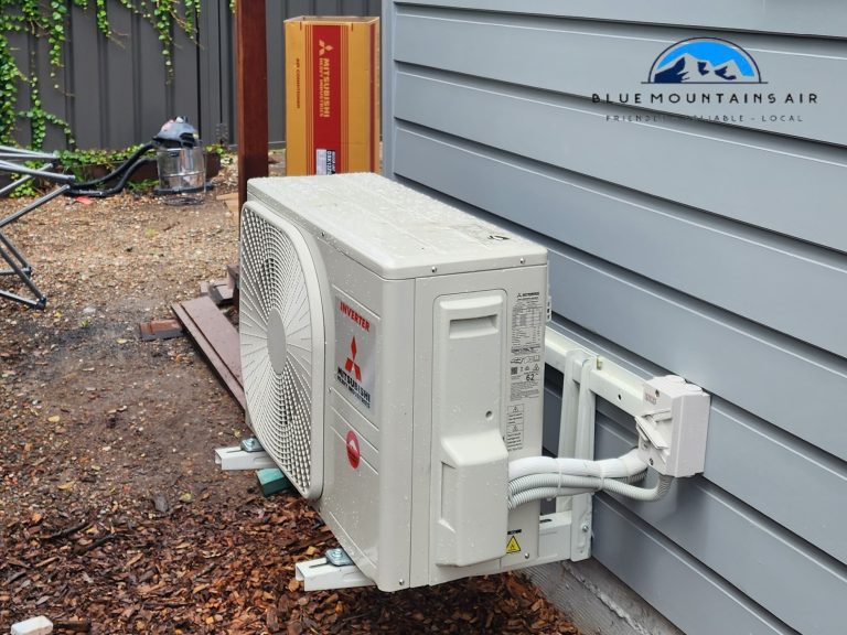 Mitsubishi inverter air conditioning unit installed on the exterior of a home