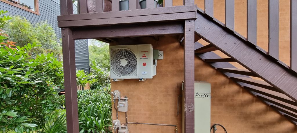 A outdoor unit of an AC under the stairs 